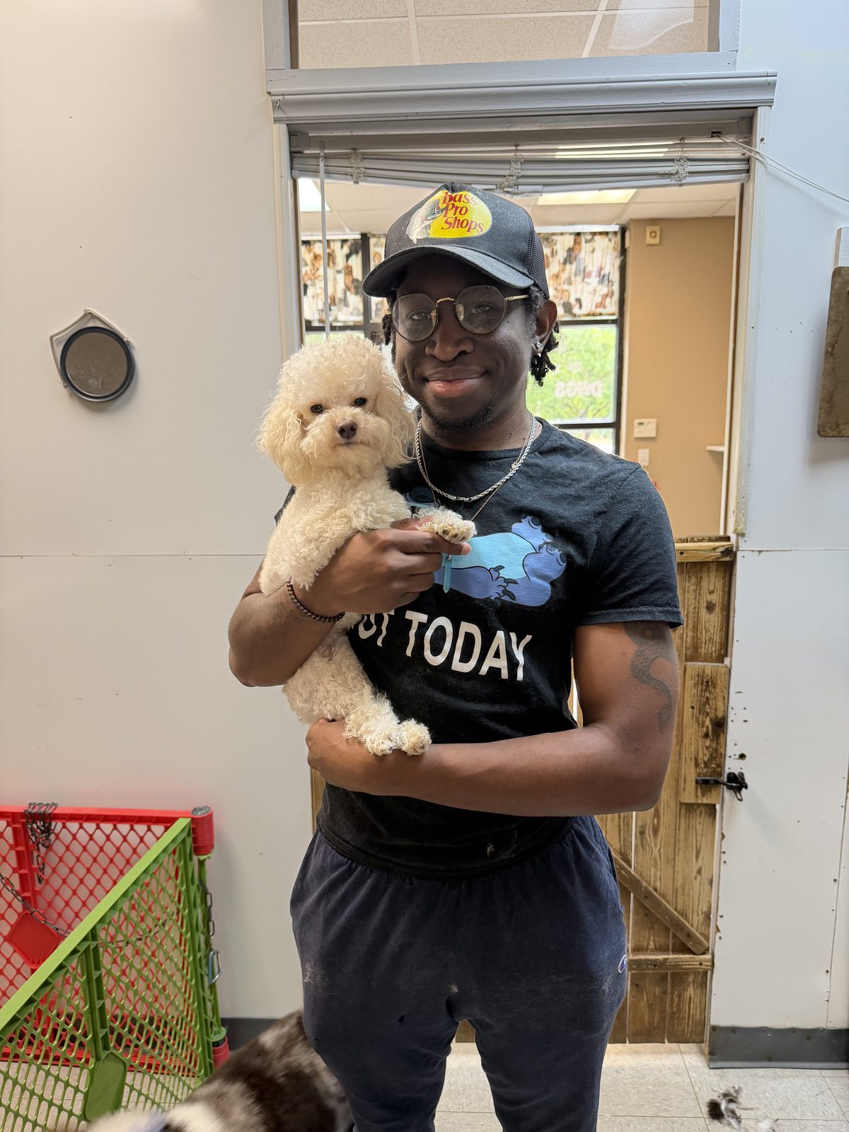 Jay, co-owner of Global Pawdicure Palace, with a small white poodle.